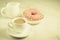 Coffee break: milk and fresh sugary pink donut/Coffee break: milk and fresh sugary pink donut on a white marble background.