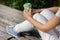 Coffee Break in the Park: Stylish Woman Enjoying a Cup of Coffee on a Sunny Spring Day