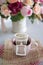 Coffee Break Time. Vertical image of A cup of Drift coffee, and Rose Flower vase place on white home office