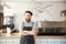 Coffee business owner concept - portrait of happy young bearded caucasian barista in apron with confident looking at