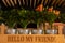 Coffee cafe decoration with tree pots, wooden box, bag and glass of coffee on shelf. Metal buckets with indoor plants in a wooden