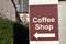 Coffee cafe shop direction arrow sign on wall