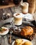 Coffee cafe table with desserts and latte drinks