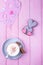 Coffee cappuccino with cinnamon and gingerbread rabbit with heart on a pink wooden background. Happy Valentine`s Day!