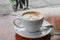 Coffee cappuccino close up on wood background