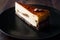 Coffee Cheesecake on Black Plate with Dark Wooden Surface.