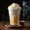 Coffee cocktail with cream and ice. Latte with orange topping. Splash of drink on a plain background.