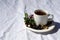 Coffee composition  with  white cup    of coffe with herb  and beans of coffe,  Chocolate,  berry, mint on  linen tableclothtable