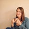 Coffee contemplation. a relaxed young woman drinking a cup of coffee at home.