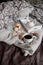Coffee with cookies in bed. Interior details. Gray background. Beautiful flat lay