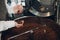 Coffee cooling in roaster machine at coffee roasting process. Young woman worker barista Mixing coffee beans.