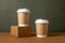 Coffee craft paper cups with place for logo on green and brown background, natural color, for menu and restaurants