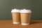 Coffee craft paper cups with place for logo on green and brown background, natural color, for menu and restaurants