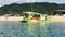 Coffee and cruise tour operator`s green catamaran at Kaiteriteri Beach, Tasman region, New Zealand