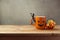 Coffee cup as jack o lantern pumpkin and candy for trick or treat on wooden table. Halloween concept