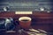 Coffee cup and camera film on retro radio background