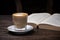 Coffee cup cappuccino hot latte or coffee with milk in a glass cup, open book