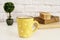 Coffee cup, cappuccino, latte, old books, cookies and bonsai on white table. Gray brick wall. Leisure lifestyle concept.