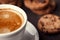 Coffee cup with chocolate cookies on dark old wooden table