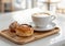 Coffee Cup and Cinnamon Roll on Wooden Tray