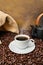 Coffee cup close-up over roasted beans