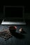 Coffee cup and coffee beans and cookie and laptop on black background