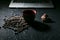 Coffee cup and coffee beans and cookie and laptop on black background