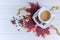 Coffee in cup and coffee beans, isolated spread on a white background with autumn red leaves