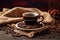 Coffee cup and coffee beans on a wooden table with burlap