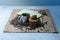 Coffee cup and coffee beans on wooden table with cookies and notepad