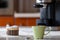 Coffee cup and coffee maker on the kitchen table. Morning coffee in the home kitchen