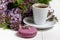 Coffee cup and colorful lilac flowers on garden table