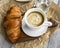 Coffee cup with croissant.Breakfast meal with fresh coffee and f