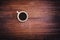 Coffee cup on dark brown wood table top view