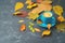 Coffee cup and fall leaves on blackboard table. Autumn concept