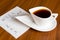 Coffee cup with handwriting week plan on napkin