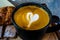 Coffee cup with heart shape foam closeup