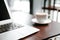 Coffee cup and laptop for business on the wooden table in coffee shop in the morning