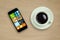 Coffee cup and Mobile phone on wood table