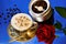 Coffee in a Cup natural invigorating delicious drink and the Queen of flowers rose for a festive joyful mood, on a bright blue