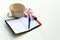 Coffee cup and notbook on white background