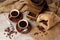 Coffee cup and old vintage coffee grinder over wooden background with sackcloth.