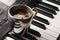 Coffee cup on piano keyboard