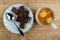 Coffee in cup, pieces of chocolate, spoon in saucer on table. Top view