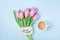 Coffee cup, pink tulip flowers and note good morning on blue table top view. Beautiful breakfast on Mothers or Womans day.