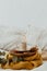 Coffee cup placed on a wooden tray and warm sweater with background bokeh blur of lights. Morning in Bed.