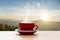 Coffee cup red with morning sunshine mountain