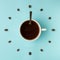 Coffee cup and roasted beans arranged as clock face on blue background, top view. Coffee time symbol. Interesting idea energy and