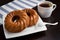 Coffee cup, round cake on table