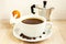 Coffee cup, saucer, beans, aluminum coffee maker, rabbit egg holder. Easter breakfast concept